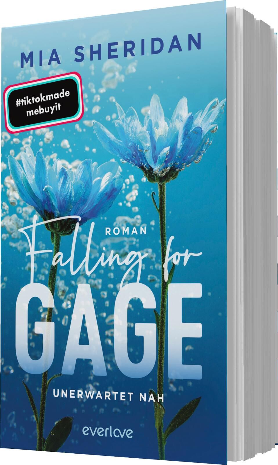 Das Buchcover zeigt eine unter Wasser befindliche Szenerie mit zwei blauen, blühenden Pflanzen, deren Stängel elegant im Wasser stehen. Der Hintergrund ist in einem sanften Aquablau gehalten, was eine frische und beruhigende Atmosphäre vermittelt. In mode